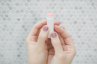 Two hands holding a moisturising lip balm Two hands holding a moisturising lip balm